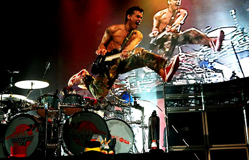 Edward Van Halen jumping in front of his brother/drummer Alex